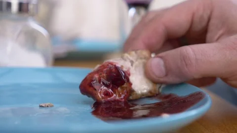 Closeup. man holds a piece of fried meat with his hand. dip in sauce Stock Footage 126276918