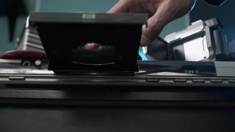 Closeup of Man Inserting Disc into DVD Player Stock Footage 169704544