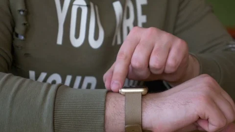 Closeup of man interacting with smartwatch in a restaurant Stock Footage 74893639
