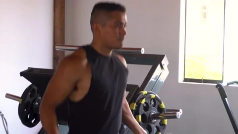 Closeup of a man jumping rope in his personal home gym Stock Footage 146502094