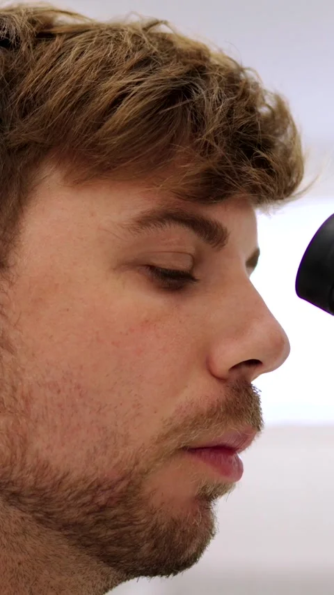 Closeup of man looking through microscope Stock Footage 258077449