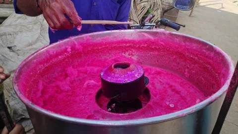 Closeup of a man making cotton candy or candy floss at the roadside Stock Footage 243003970