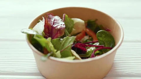 Closeup of man making a fresh healthy salad in a zero waste container to go.  Stock Footage 305097507