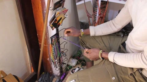 Closeup of a man making hand braslets Stock Footage 162973073