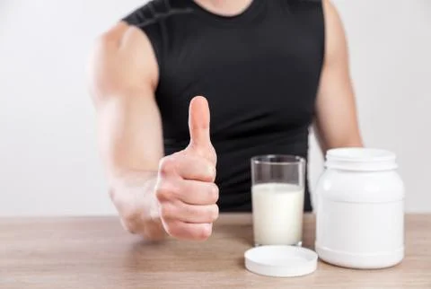 Closeup on a man with nutiotion supplements on table Stock Photos