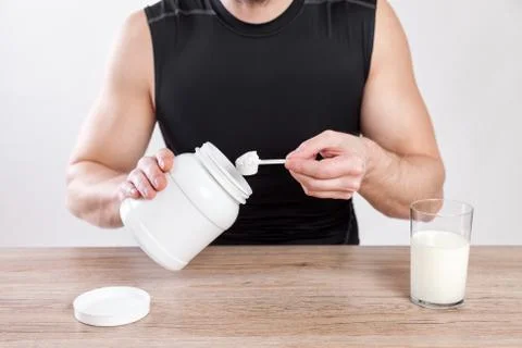 Closeup on a man with nutiotion supplements on table Foto stock