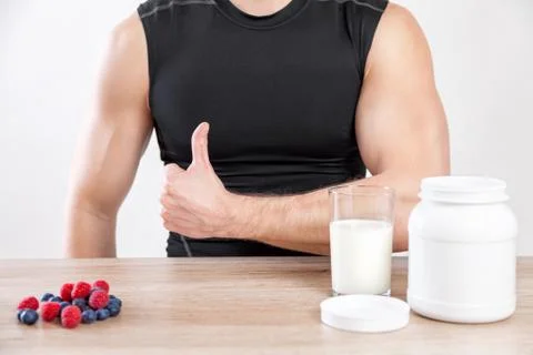 Closeup on a man with nutiotion supplements on table Foto stock
