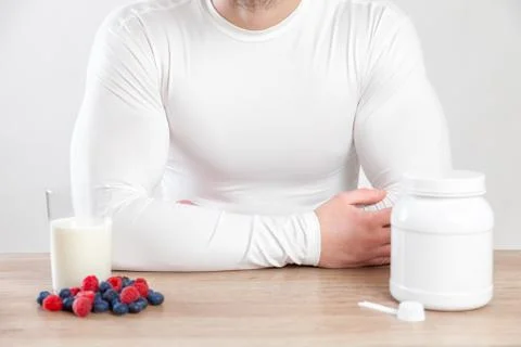 Closeup on a man with nutiotion supplements on table Stock Photos
