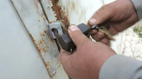 Closeup of man opening barn lock with keys Stock Footage 36524745