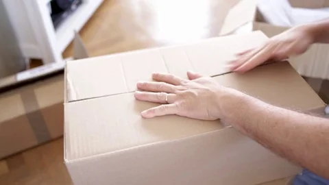 Closeup of Man Packing Boxes - House Moving Concept Stock Footage 77157550