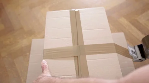 Closeup of Man Packing Boxes - House Moving Concept Stock Footage 77157575