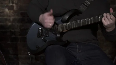 Closeup of a man playing guitar Stock Footage 74198357
