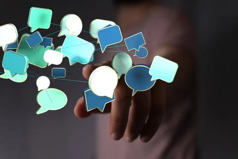 A closeup of a man pointing into 3D rendered digital speech bubbles teamwork  Stock Photos