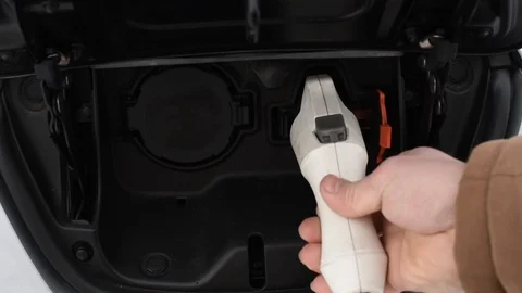 Closeup of a man putting an e-car on recharging Stock Footage 101687415