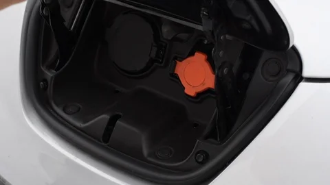 Closeup of a man putting an e-car on recharging Stock Footage 101687425