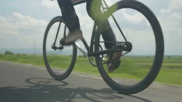 Closeup - Man riding fast with a black fixed gear bike 4K Stock Footage 85552779