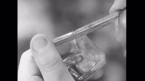 Closeup of man rotating broken harmonica part, 1930s Stock Footage 260257403