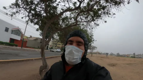 Closeup of a man running with mask and overalls in a field with trees Vidéo 140564772