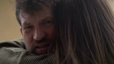 Closeup of man scared about recession after coronavirus crying hugging girlfr Stock Footage 128430711