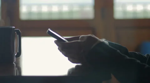 Closeup of man scrolling through email and information on smart phone Видео 65338803