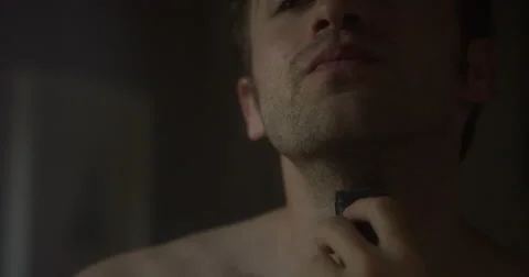 Closeup of a man shaving with an electric razor in a mirror / slow motion Stock Footage 64033239