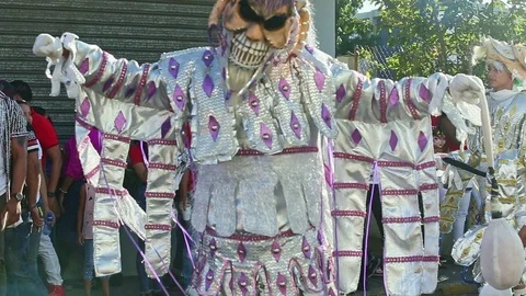 Closeup man in shining devil costume dance on city street at dominican carnival Video stock 122651737