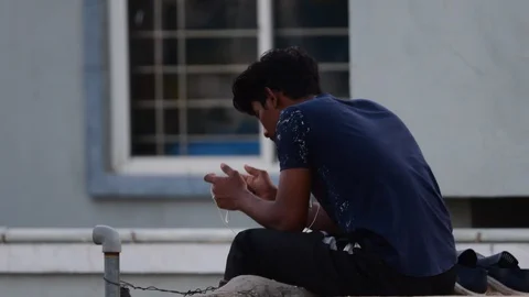 Closeup-man-sitting-on-terrace-using-mobile-phone Stock Footage 128227152