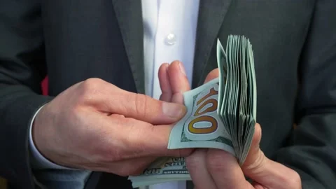 Closeup man in suit showing stack of dollars. Successfully completed deal Stock Footage 234074280