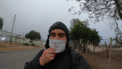 Closeup of a man taking off his mask while running in his biosecurity suit 库存影片 140560931