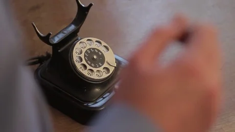 Closeup of a man talking on an old phone gesticulating and twisting in his hand Stock Footage 82184873
