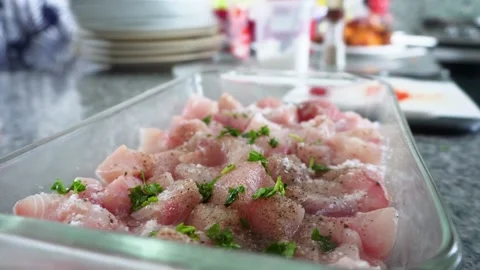 Closeup of a man throwing herbs with his hands to a Ceviche platter with Jurel Stock Footage 178214615
