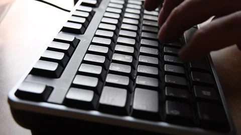 Closeup of a man typing on a computer keyboard Stock Footage 89076075