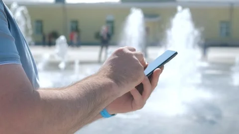 Closeup of man typing text message on smartphone or hands using mobile phone in Video stock 258655632