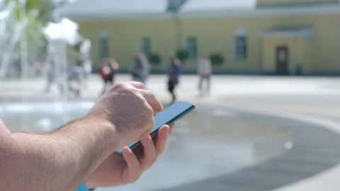 Closeup of man typing text message on smartphone or hands using mobile phone in Stock Footage 267865321