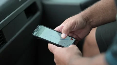 Closeup of a man using GPS and Google maps navigation in his phone in a car Stock Footage 221708409
