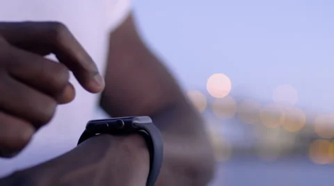 Closeup Of Man using His Smartwatch With City Lights In Background Video stock 67971061