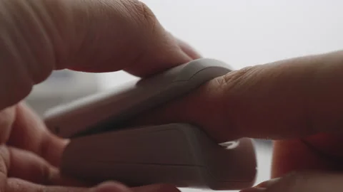 CLOSEUP: Man using Oximeter at home Видео 133230392