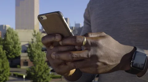 Closeup Of Man Using Smart Phone, City Skyline In Background Stock Footage 67879994