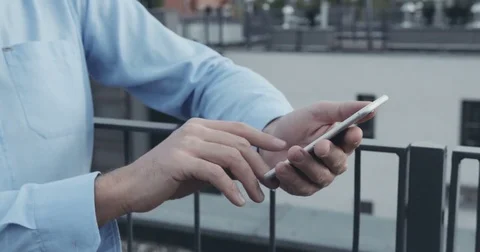Closeup of man using smartphone on building roof Stock Footage 70309243