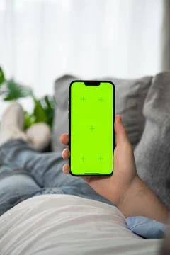 Closeup of man using smartphone with green screen tapping on the screen. Mobile Stock Photos
