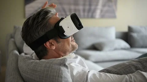 Closeup of man using virtual reality headset, VR mask Stock Footage 61682951