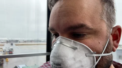 Closeup of Man Wearing Face Mask at Airport during Global Pandemic Stock Footage 126660931