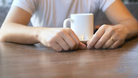 Closeup. the man wears a wedding ring, sitting in a cafe. Stock Footage 126782534