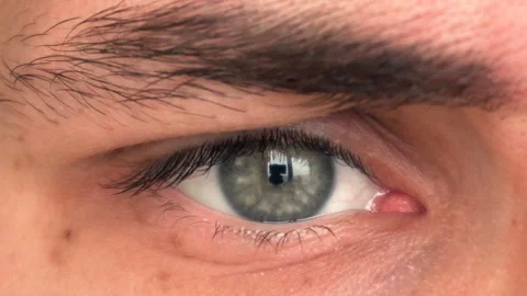 Closeup of man's eye moving looking around Stock Footage 87875420