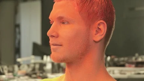 Closeup of man's face with the bright orange makeup Stock Footage 73540856