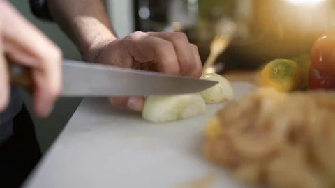 Closeup of mans' hand cutting vegetables in home kitchen Video stock 103287207