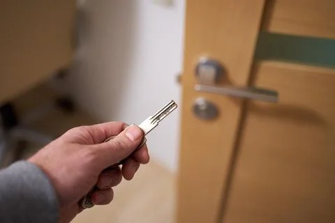 Closeup of man's hand going to close the half opened interior door 스톡 사진