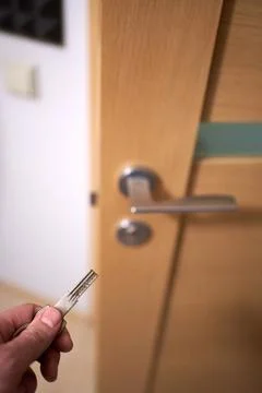 Closeup of man's hand going to close the half opened interior door Stock Photos