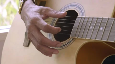 Closeup of a man's hand playing a guitar. Stock Footage 240272316