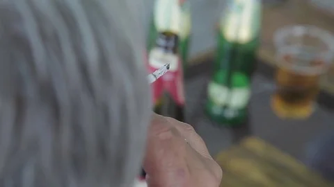 Closeup of man's hand with a Smoking cigarette in a cafe on the street Video stock 71915420